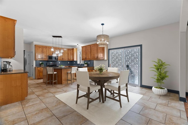 dining space with light tile patterned floors and a notable chandelier