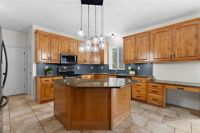 kitchen with built in desk, a center island, hanging light fixtures, dark stone countertops, and electric range