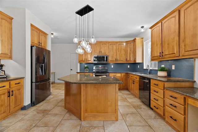 kitchen with a kitchen island, dark stone counters, decorative backsplash, appliances with stainless steel finishes, and hanging light fixtures