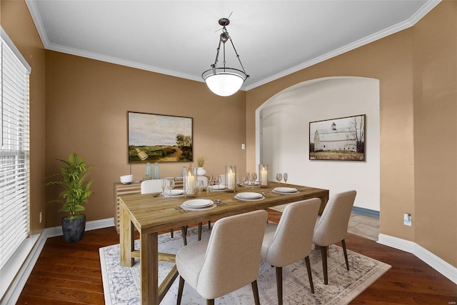 dining area with wood finished floors, baseboards, and ornamental molding