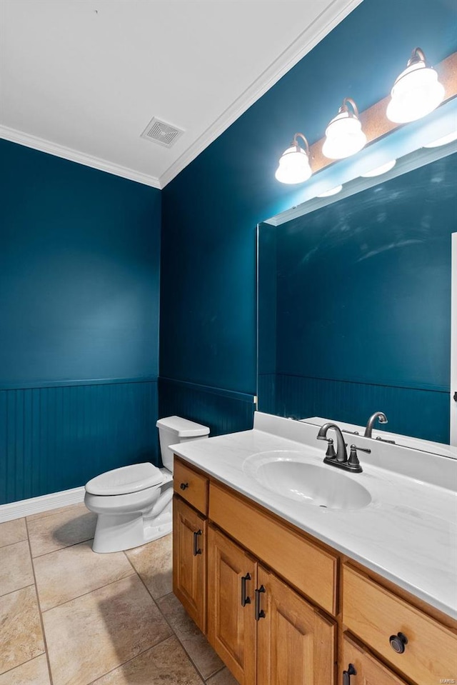 bathroom with crown molding, vanity, tile patterned floors, and toilet