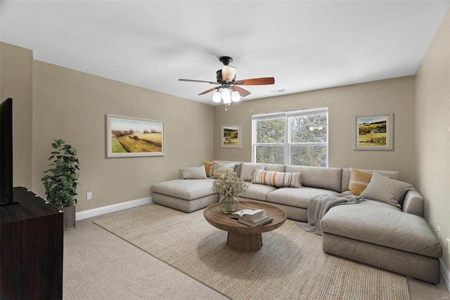 carpeted living area with visible vents, baseboards, and ceiling fan