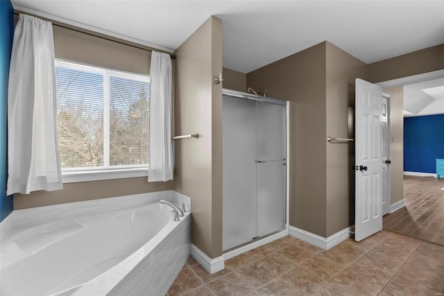 bathroom with tile patterned floors and separate shower and tub