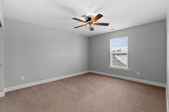 carpeted spare room featuring ceiling fan