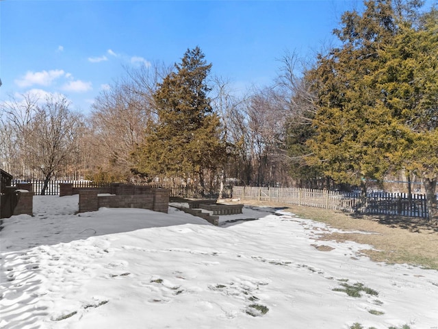 view of yard layered in snow