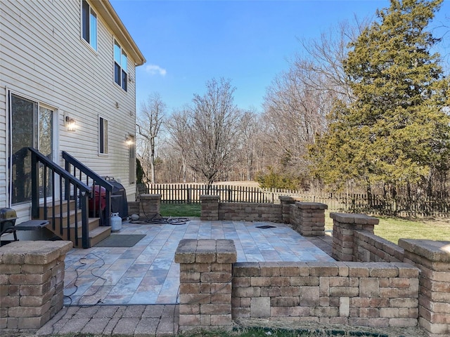 view of patio with entry steps and fence