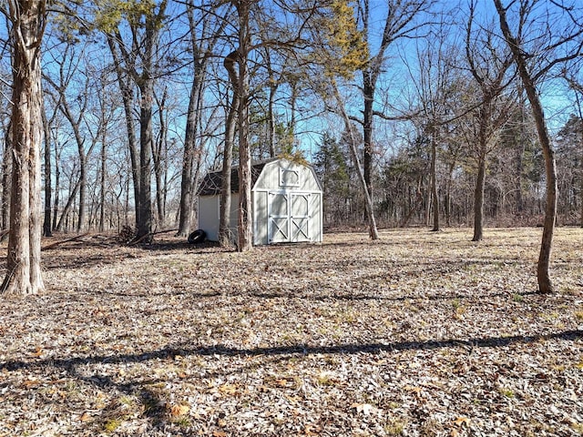 view of yard featuring a storage unit and an outbuilding