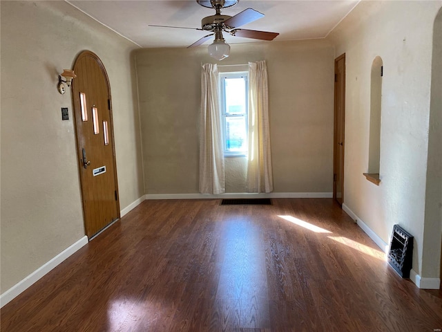 unfurnished room featuring ceiling fan and dark hardwood / wood-style floors