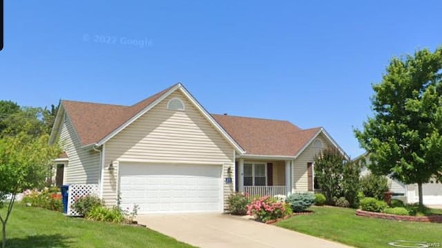 single story home featuring a front lawn and a garage