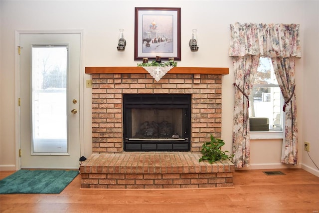 living room featuring hardwood / wood-style flooring and a fireplace