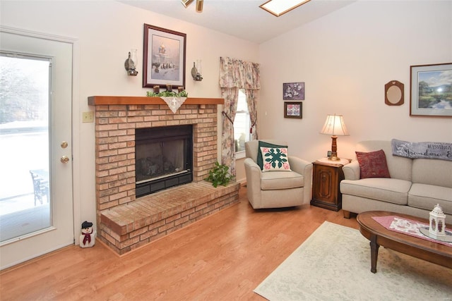 living room featuring hardwood / wood-style floors, plenty of natural light, and a fireplace