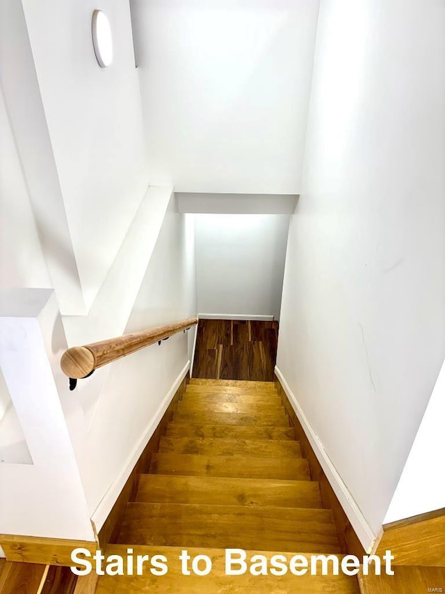 stairs with wood-type flooring