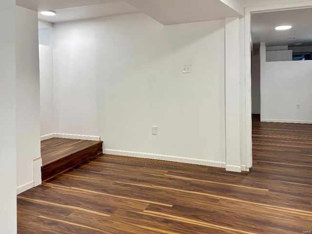 empty room with dark hardwood / wood-style flooring