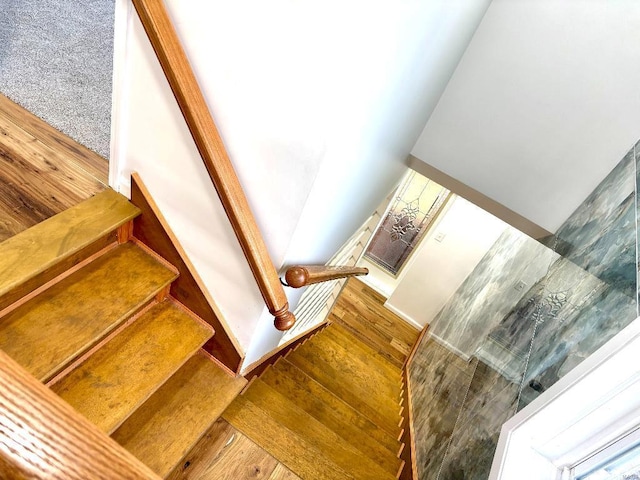 stairs featuring wood-type flooring