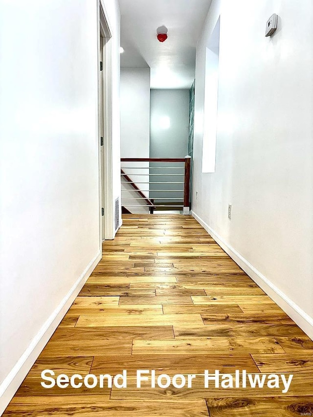 hallway with light hardwood / wood-style flooring