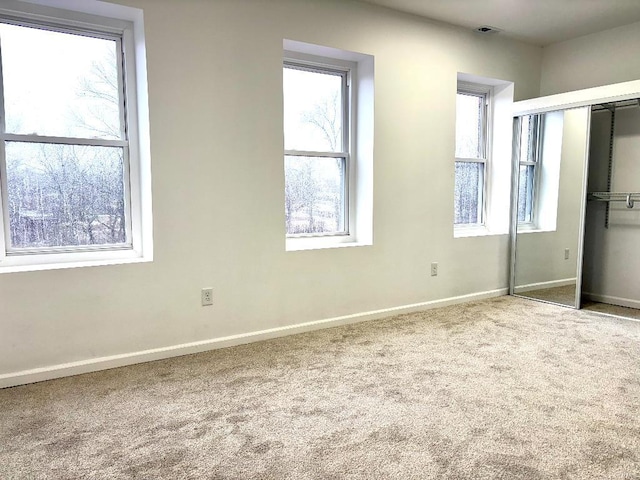 unfurnished bedroom with carpet floors and a closet