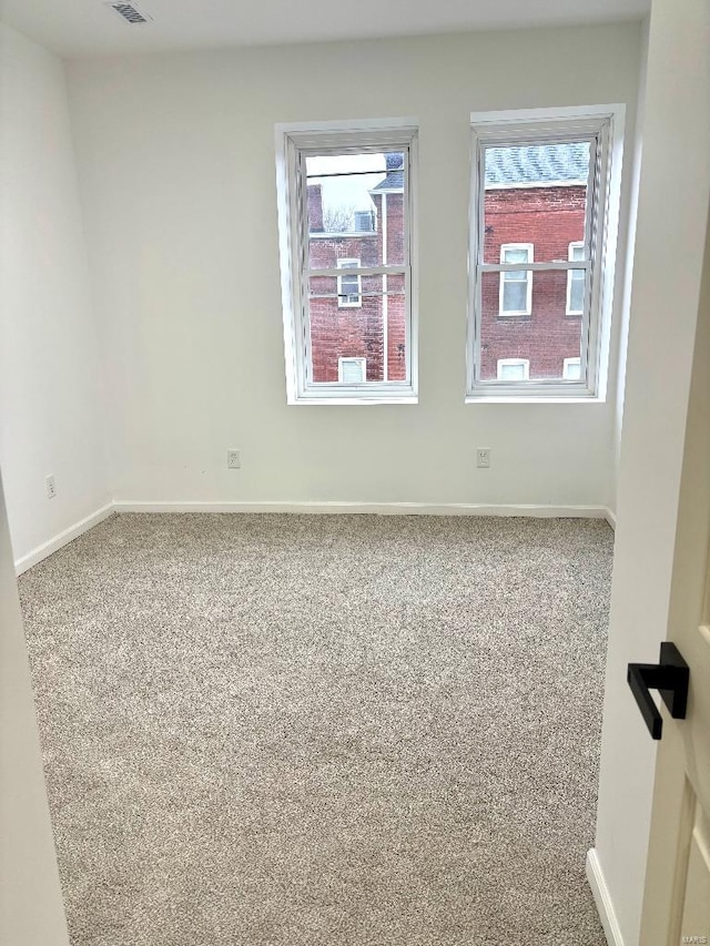 unfurnished room featuring carpet