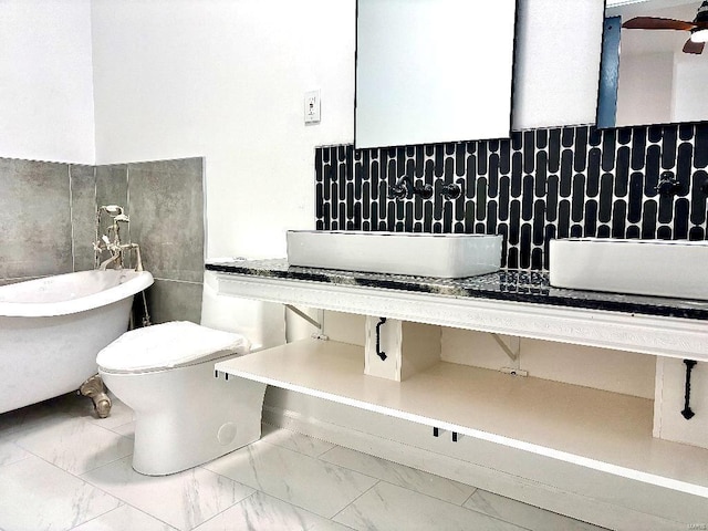 bathroom featuring tasteful backsplash, ceiling fan, and toilet