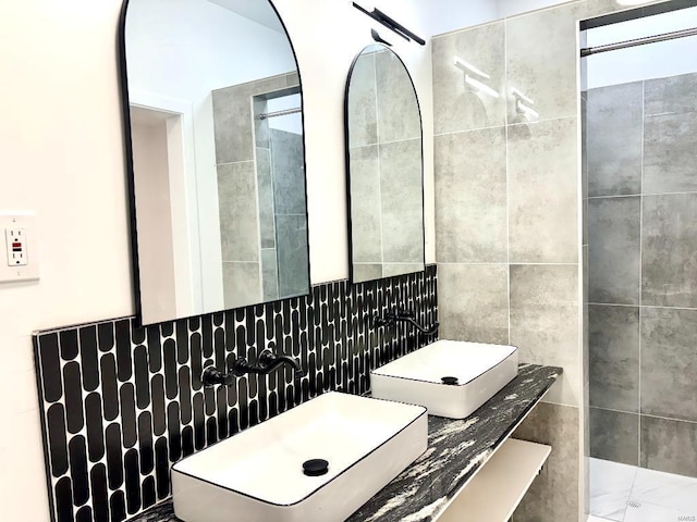 bathroom with sink and tile walls