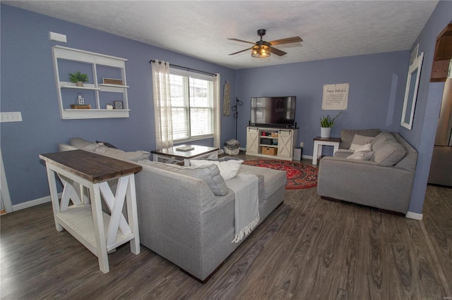 living room featuring dark hardwood / wood-style floors, a textured ceiling, and ceiling fan