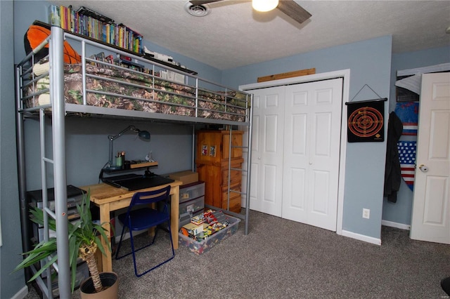 carpeted bedroom with ceiling fan, a closet, and a textured ceiling