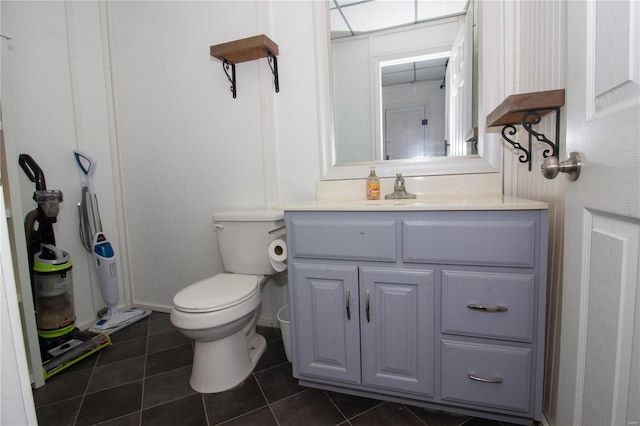 bathroom with tile patterned floors, vanity, and toilet