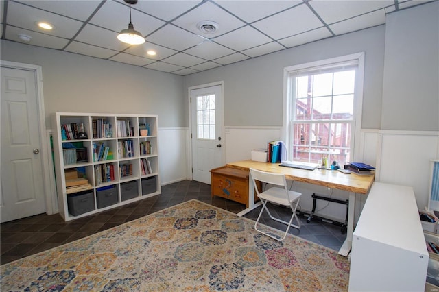 office featuring a paneled ceiling and dark tile patterned flooring