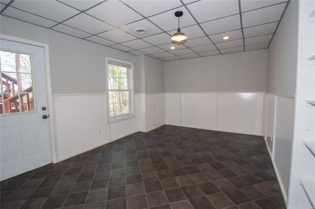 unfurnished room featuring recessed lighting, wainscoting, visible vents, and a paneled ceiling