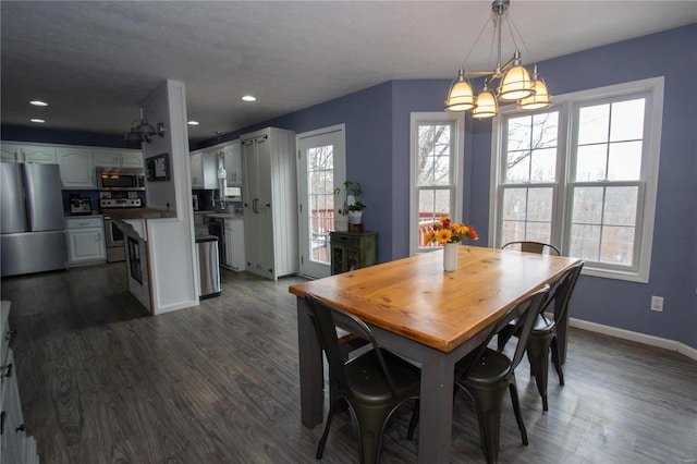 dining space featuring baseboards, recessed lighting, a chandelier, and dark wood finished floors