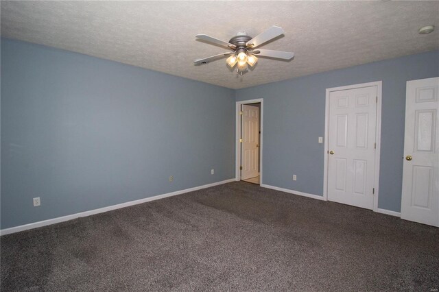 unfurnished room featuring a textured ceiling, baseboards, a ceiling fan, and dark colored carpet