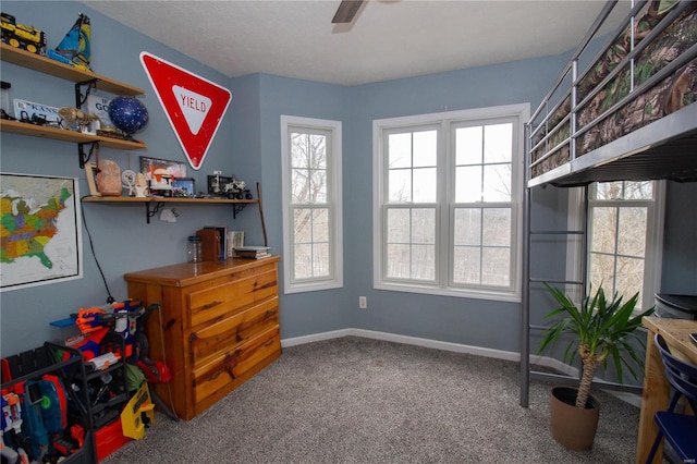 interior space featuring ceiling fan, a wealth of natural light, and baseboards