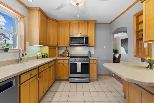 kitchen featuring sink, crown molding, ceiling fan, backsplash, and stainless steel appliances