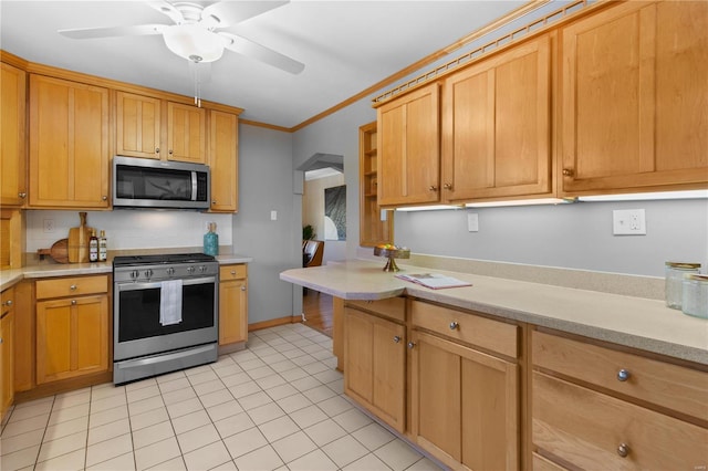 kitchen with ceiling fan, ornamental molding, appliances with stainless steel finishes, and light tile patterned flooring