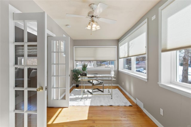 office featuring hardwood / wood-style flooring, ceiling fan, and french doors