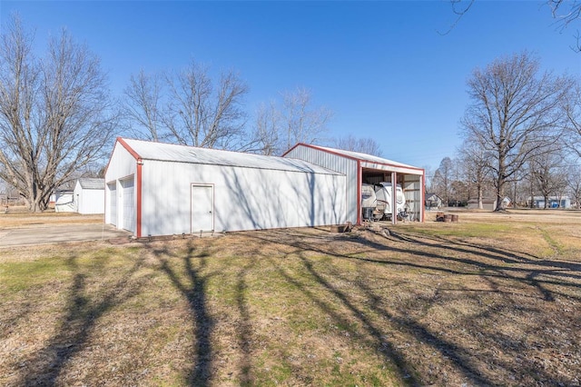 view of outdoor structure featuring a garage and a lawn