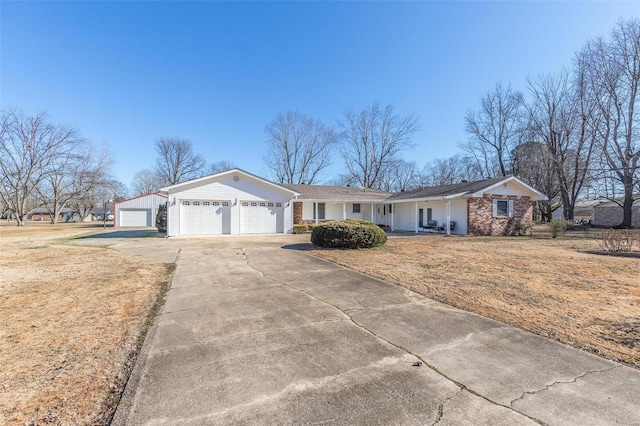 ranch-style home with a garage and a front lawn