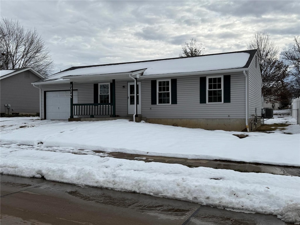 view of front facade featuring a garage and central AC