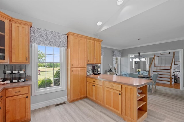 kitchen featuring kitchen peninsula, decorative backsplash, hanging light fixtures, light wood-type flooring, and a chandelier