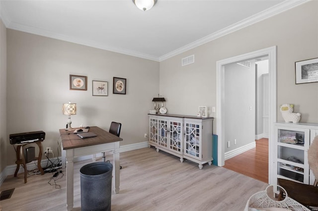 office space featuring light wood-type flooring and ornamental molding