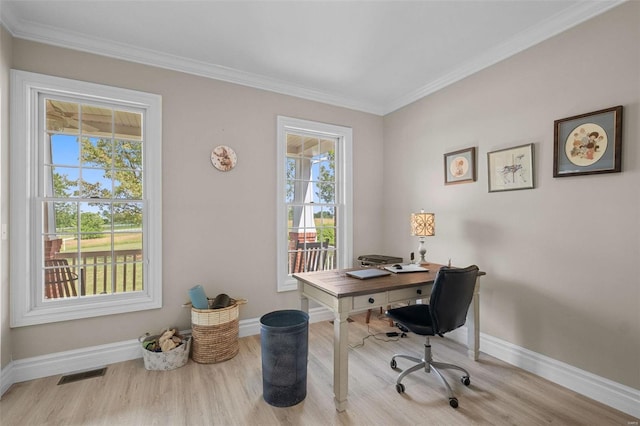 office space with ornamental molding and light hardwood / wood-style floors