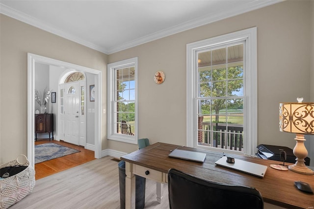 office space featuring light wood-type flooring and ornamental molding