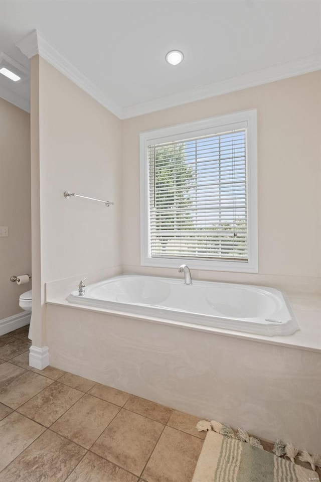 bathroom featuring a tub to relax in, tile patterned flooring, toilet, and crown molding