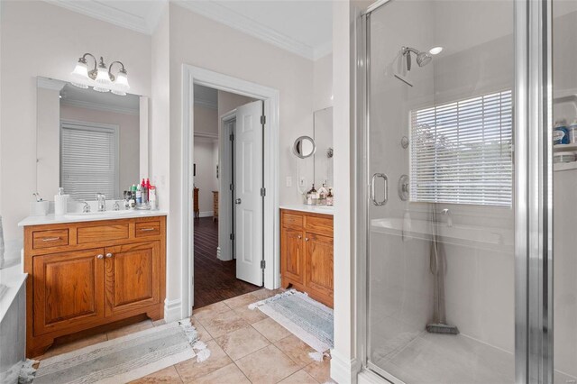 bathroom featuring a shower with door, vanity, ornamental molding, and tile patterned flooring