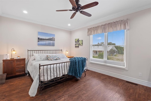 bedroom featuring ceiling fan, dark hardwood / wood-style flooring, and crown molding