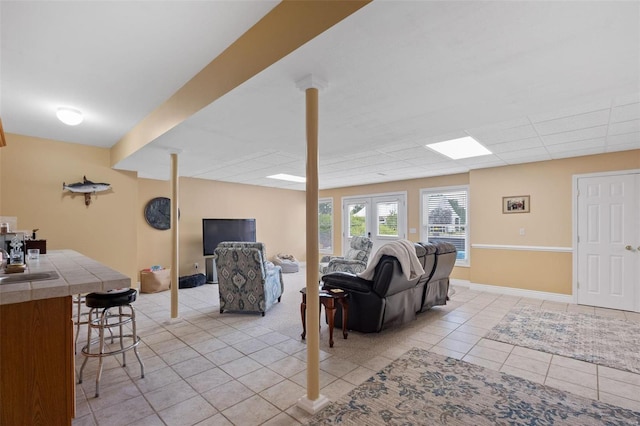 tiled living room with french doors and sink