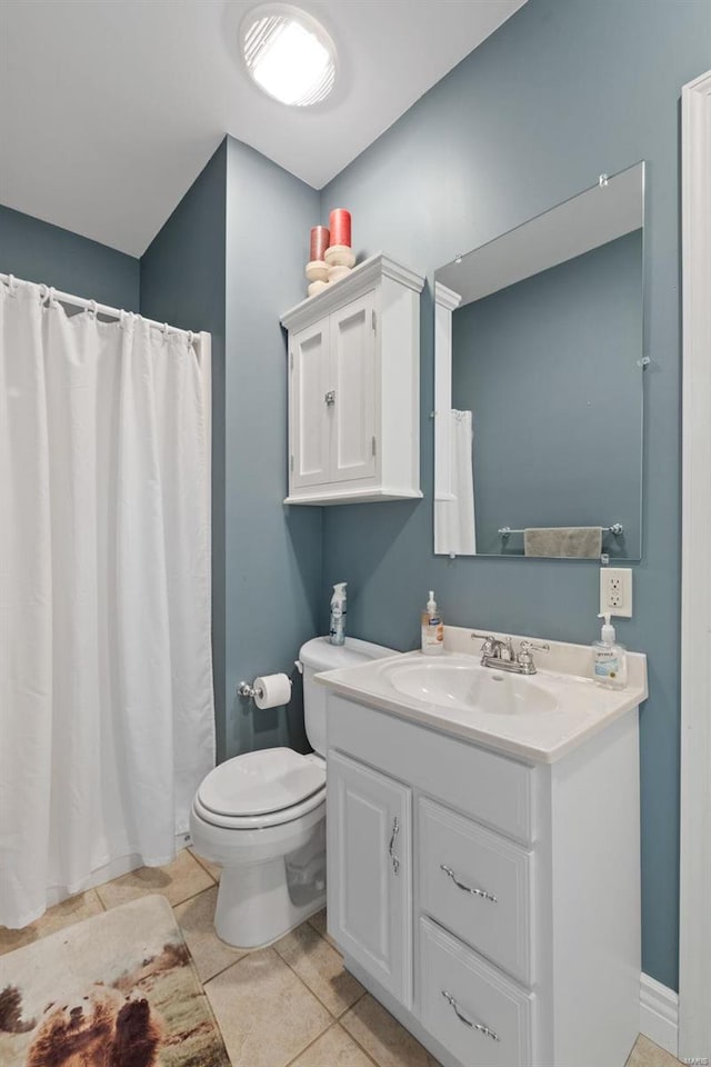 bathroom featuring toilet, tile patterned flooring, and vanity