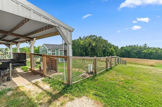 view of yard with a rural view, central air condition unit, and an outdoor structure