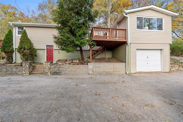 view of front of property with a deck and a garage