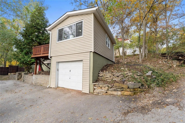 view of home's exterior featuring a garage and a wooden deck