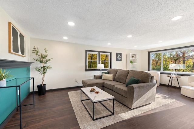 living room with dark hardwood / wood-style flooring and a textured ceiling